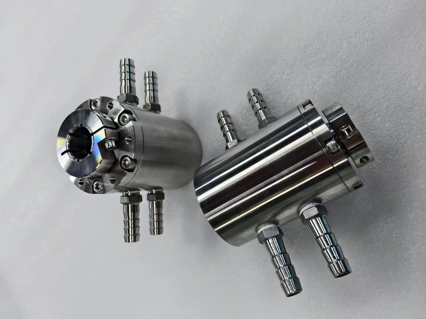Stainless steel cylindrical assemblies with hose fittings